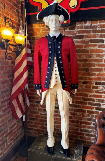 Historic Colonial military uniform displayed on a mannequin beside an American flag